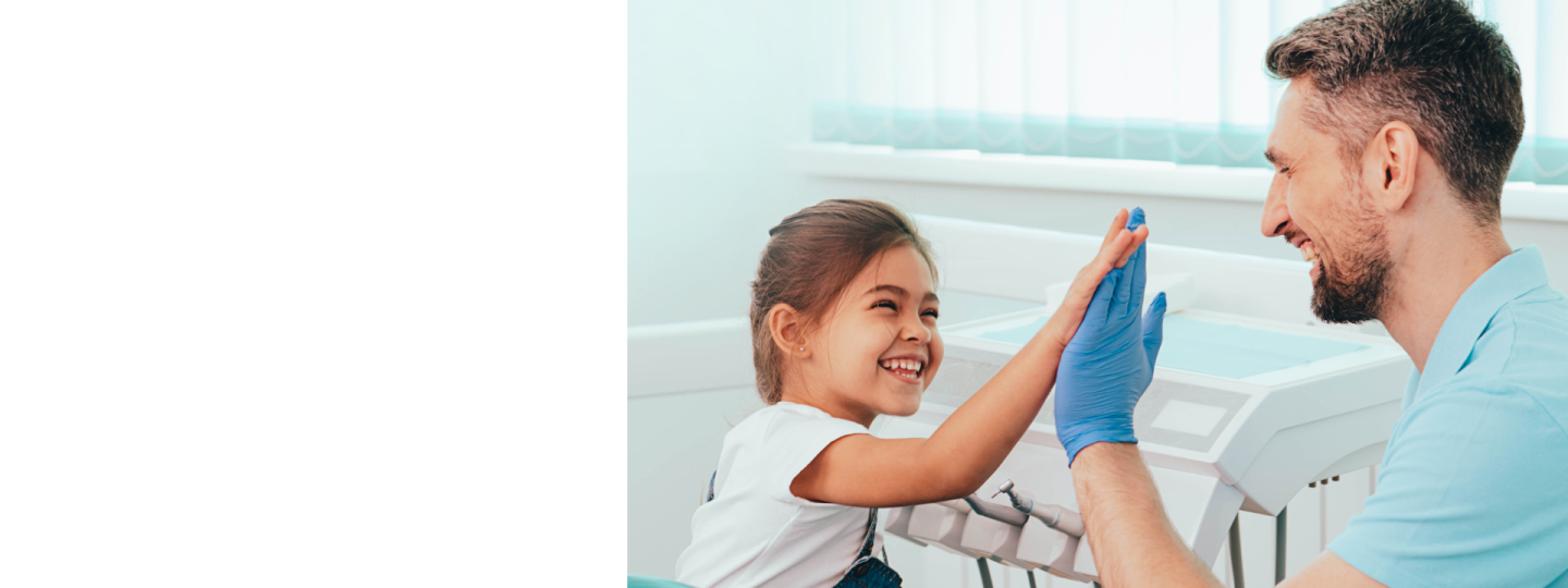 Little girl 'high fiving' a dentist.